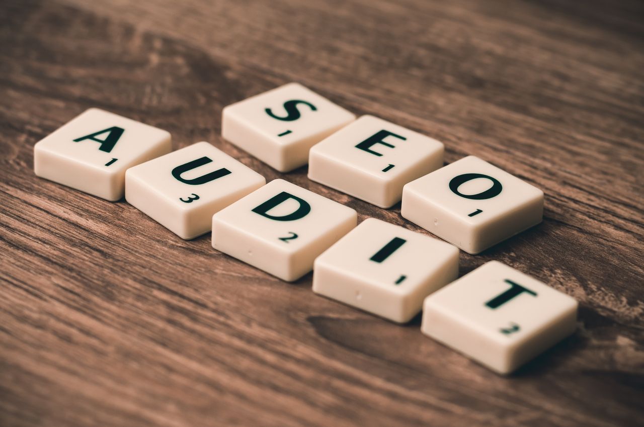 About Scrabble tiles spelling SEO Audit on wooden surface, symbolizing digital marketing strategies.