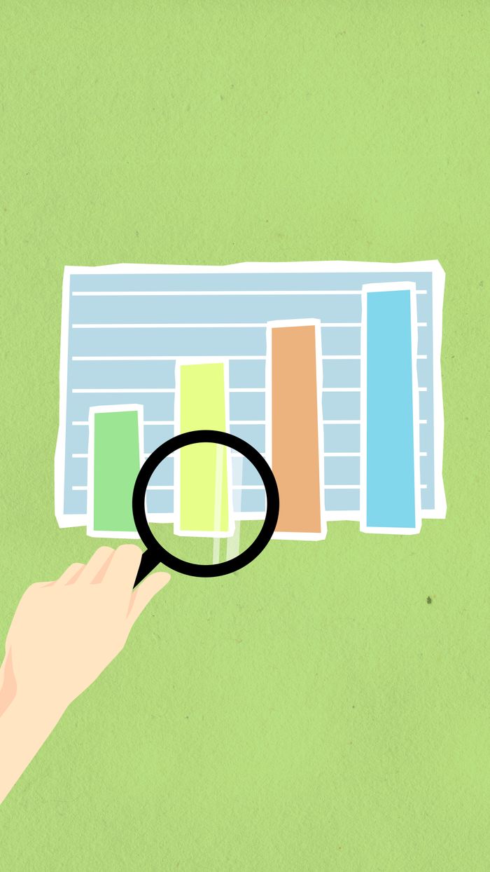 Services Top view of decorative cardboard illustration of hand with magnifying glass above diagram with columns on green background